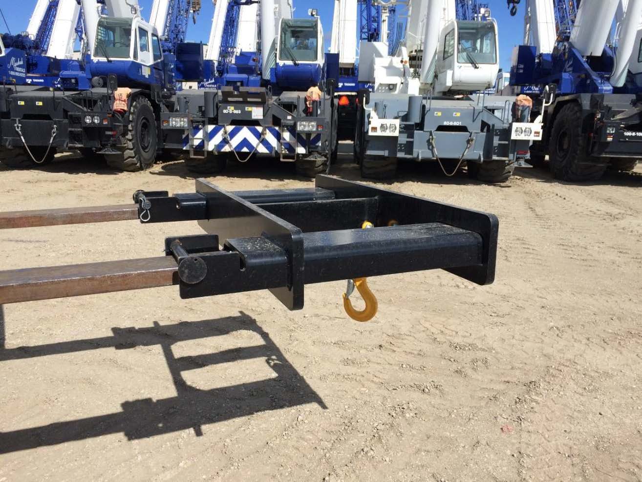 heavy lifting device with cranes in background