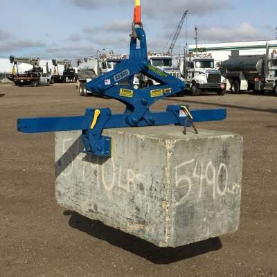 Multi lift igging device holding a block of concrete in air.
