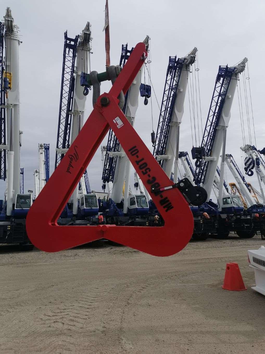 Bridge Beam Clamp with cranes in background.