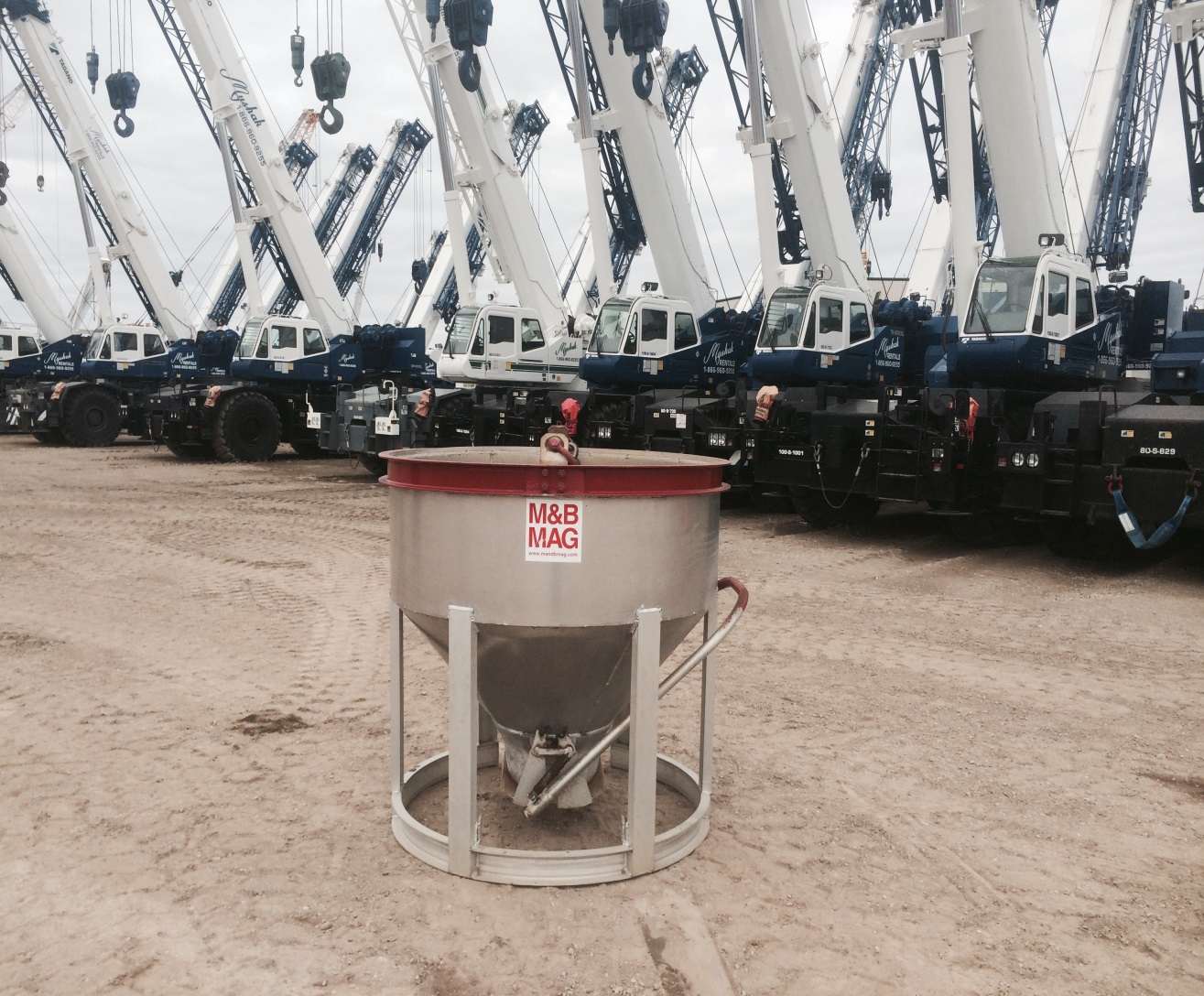 Concrete Bucket with cranes behind